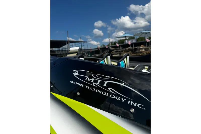 Slide: The Image of MTI 48 boat, 2022 model, with Marine Technology Inc. logo under a clear blue sky. - 15