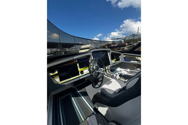 Slide: The Image of Interior of a 2022 MTI 48 boat with modern dashboard and steering wheel. - 1