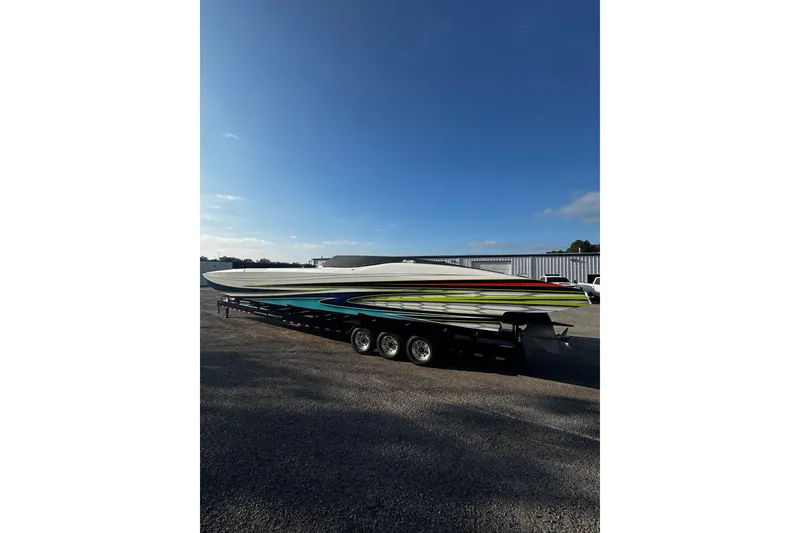 Slide: The Image of 2022 MTI 48 boat on trailer under clear blue sky. - 19