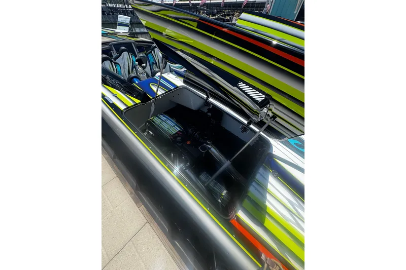 Slide: The Image of 2022 MTI 48 boat with open engine compartment, vibrant striped design. - 12