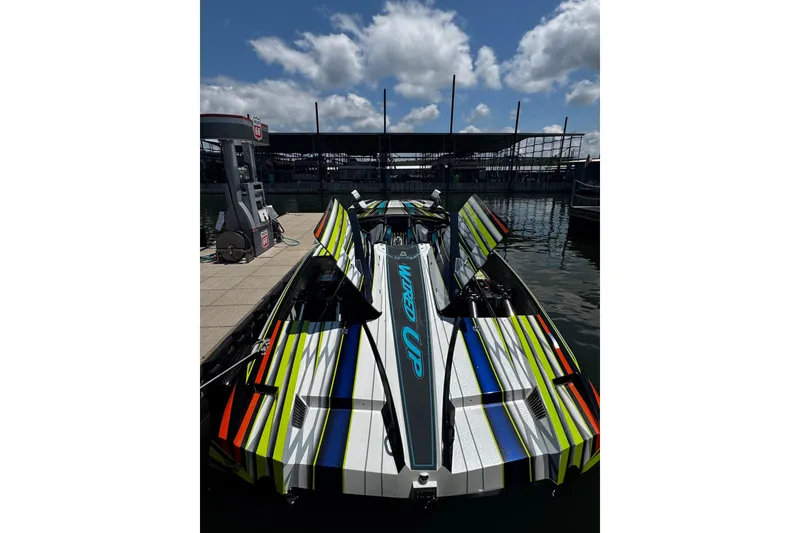 Slide: The Image of Colorful 2022 MTI 48 speedboat docked at marina under blue sky. - 7