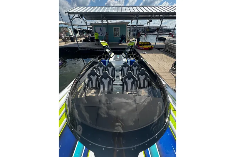 Slide: The Image of 2022 MTI 48 boat with sleek design, docked at marina under clear sky. - 6