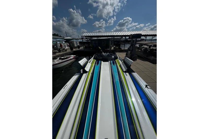 Slide: The Image of Colorful MTI 48 speedboat docked under a cloudy sky, 2022 model. - 10