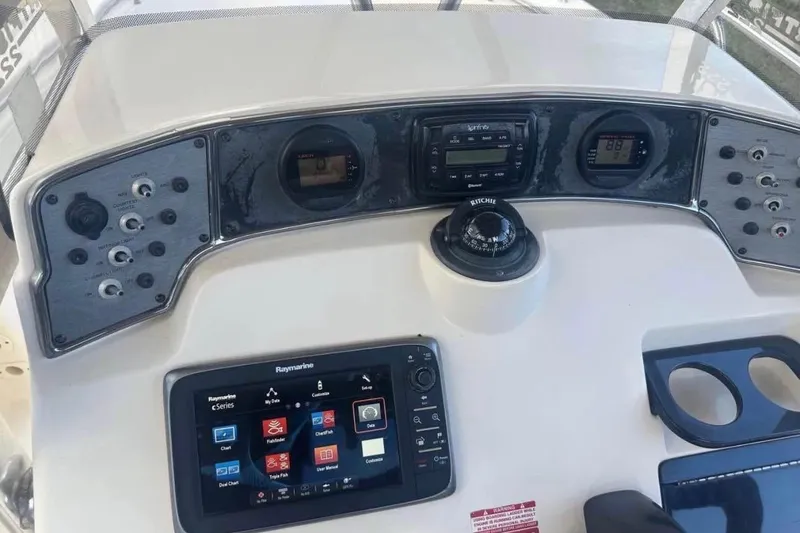 Slide: The Image of Control panel of a 2012 Scout 225 XSF boat with navigation instruments. - 8