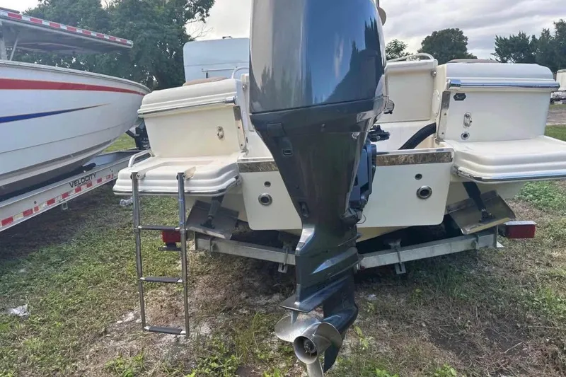 Slide: The Image of Rear view of a 2012 Scout 225 XSF boat with outboard motor and ladder. - 5