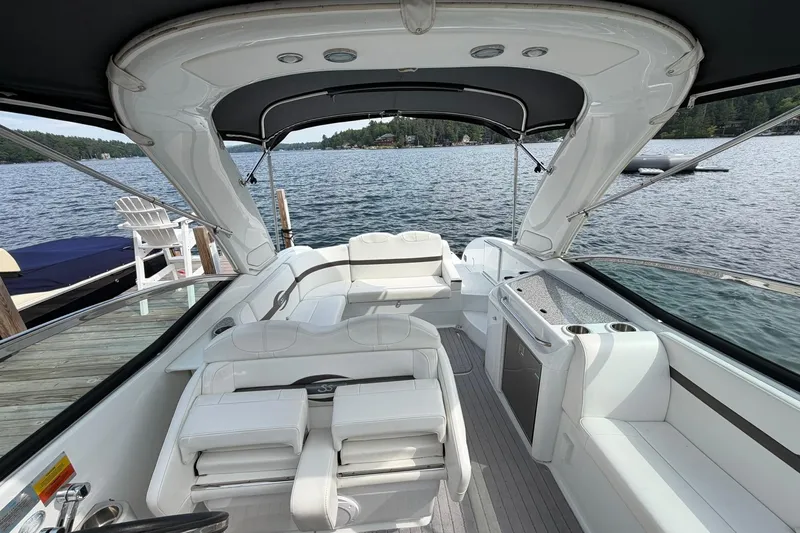 Slide: The Image of 2009 Formula 310 Sun Sport boat interior with white seating and lake view. - 6