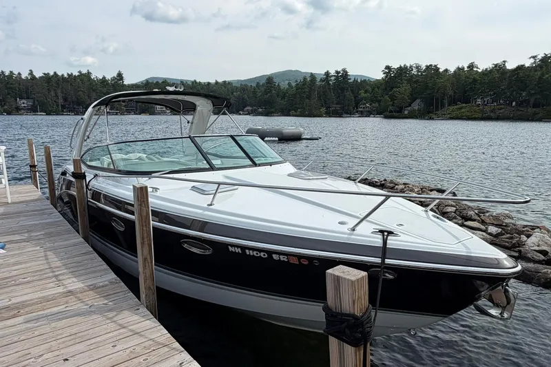 Slide: The Image of 2009 Formula 310 Sun Sport boat docked on a scenic lake with wooded shoreline. - 1