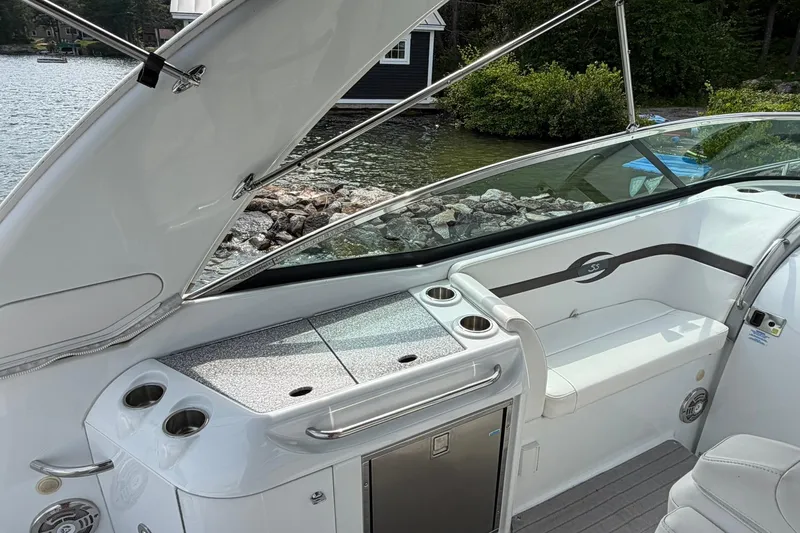 Slide: The Image of 2009 Formula 310 Sun Sport boat interior with seating and lake view. - 8