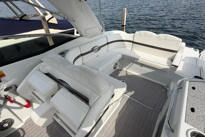 Slide: The Image of 2009 Formula 310 Sun Sport boat interior with white seating and lake view. - 9