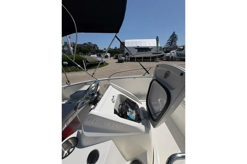 Slide: The Image of 2024 Boston Whaler 130 Super Sport boat interior with open storage compartment. - 6