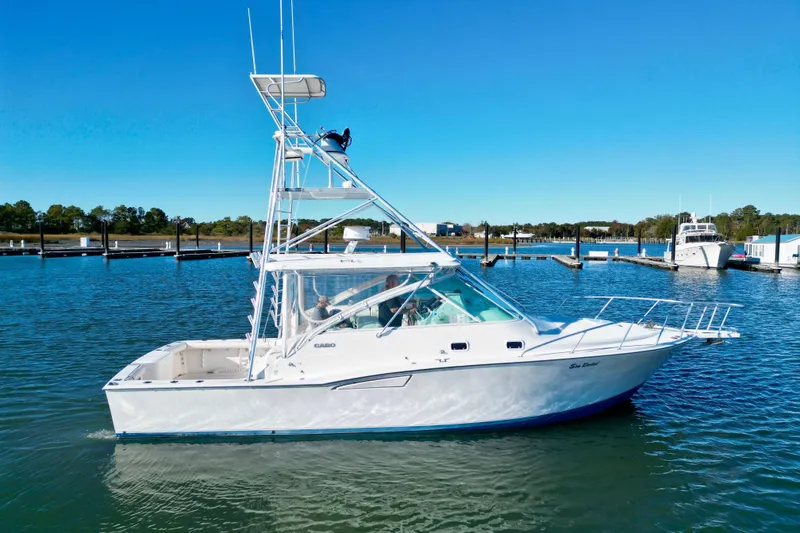 Slide: The Image of 1996 Cabo 35 Express boat on calm water with clear blue sky. - 1
