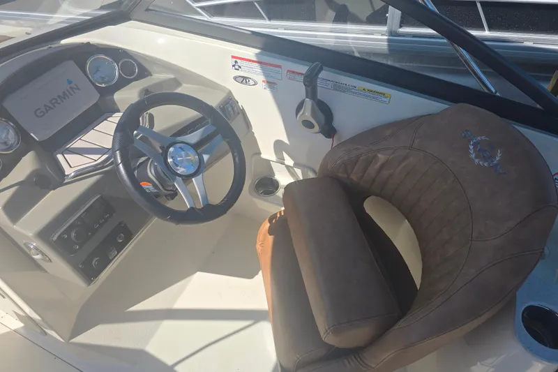 Slide: The Image of 2021 Stingray 201 DC boat cockpit with Garmin display and leather captain's chair. - 6