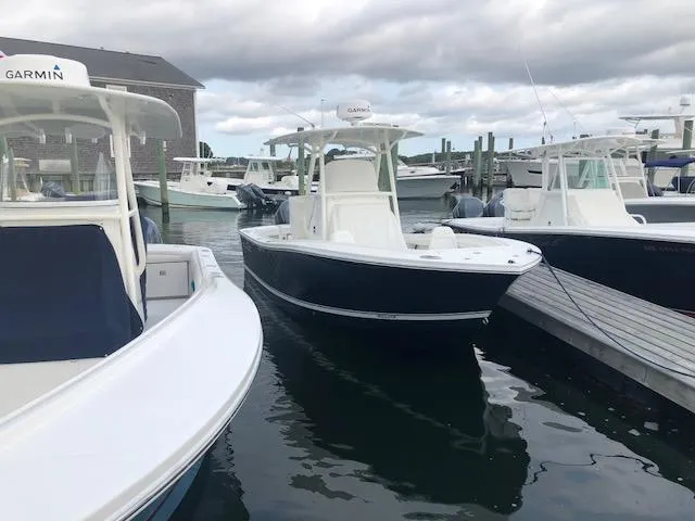 The Image of A 2019 Regulator 23 Forward Seating boat is docked in the water, surrounded by other boats. - 0