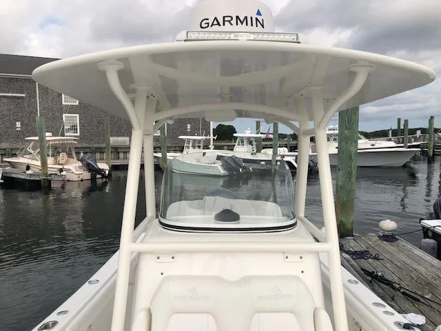 Slide: The Image of A 2019 Regulator 23 Forward Seating boat docked, featuring Garmin equipment on the roof. - 10