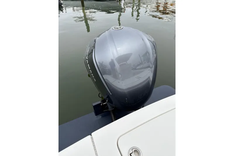 Slide: The Image of 2019 Regulator 23 Forward Seating boat with Yamaha outboard motor on calm water. - 16