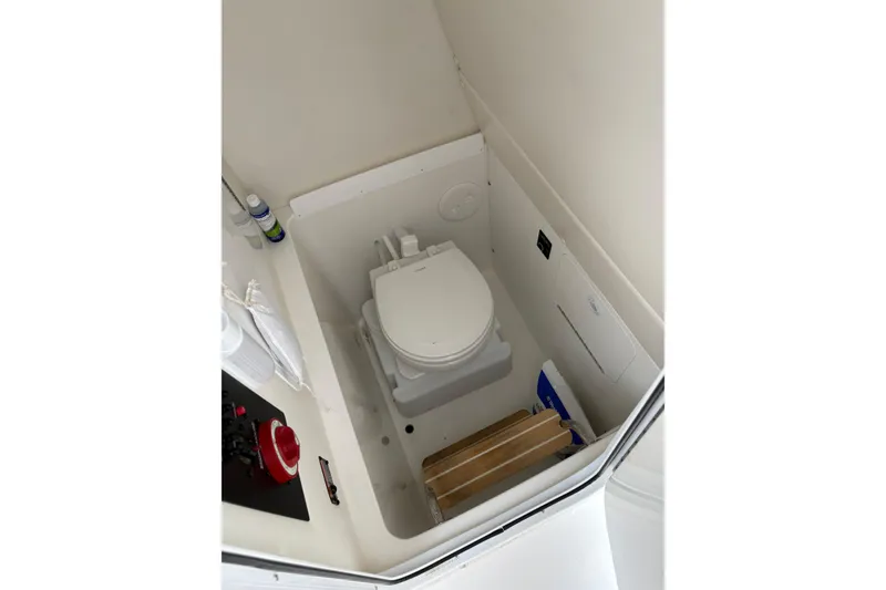 Slide: The Image of 2019 Regulator 23 Forward Seating boat interior with compact marine toilet. - 17