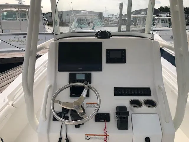 Slide: The Image of The image shows the helm of a 2019 Regulator 23 Forward Seating boat. - 9