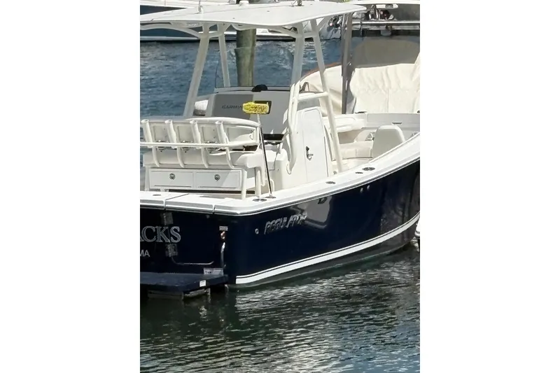 Slide: The Image of 2019 Regulator 23 Forward Seating boat docked on water. - 7