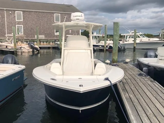 Slide: The Image of A 2019 Regulator 23 Forward Seating boat docked. It features a Garmin radar. - 2