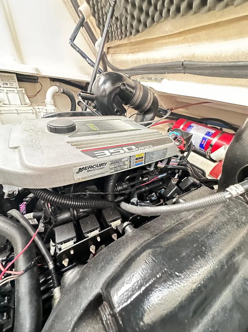 Slide: The Image of Engine compartment of a 2015 Sea Ray 260 Sundancer boat, featuring a Mercury 350 engine. - 28