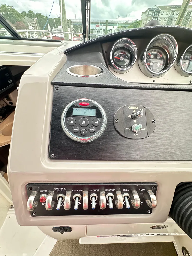Slide: The Image of Control panel of a 2015 Sea Ray 260 Sundancer boat with gauges and switches. - 11