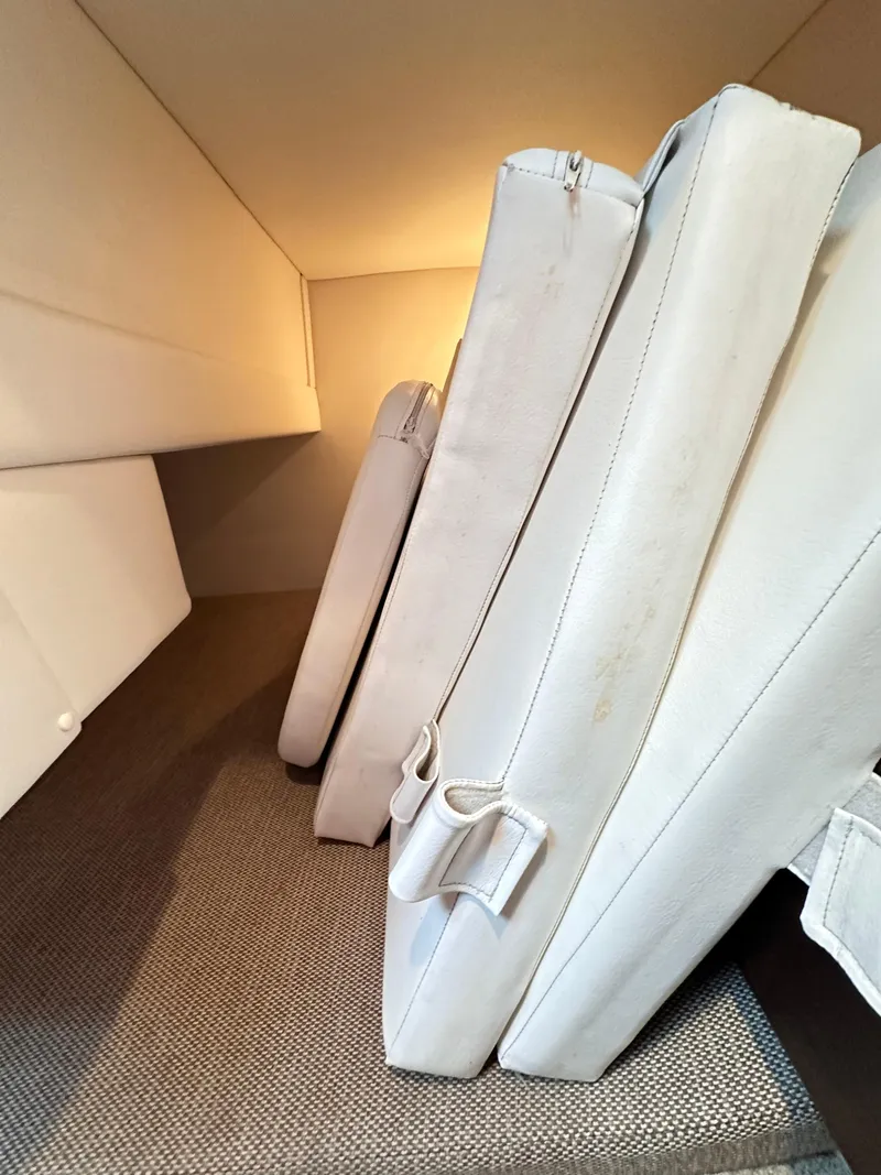 Slide: The Image of Cushioned interior of 2015 Sea Ray 260 Sundancer boat, featuring white upholstery. - 23