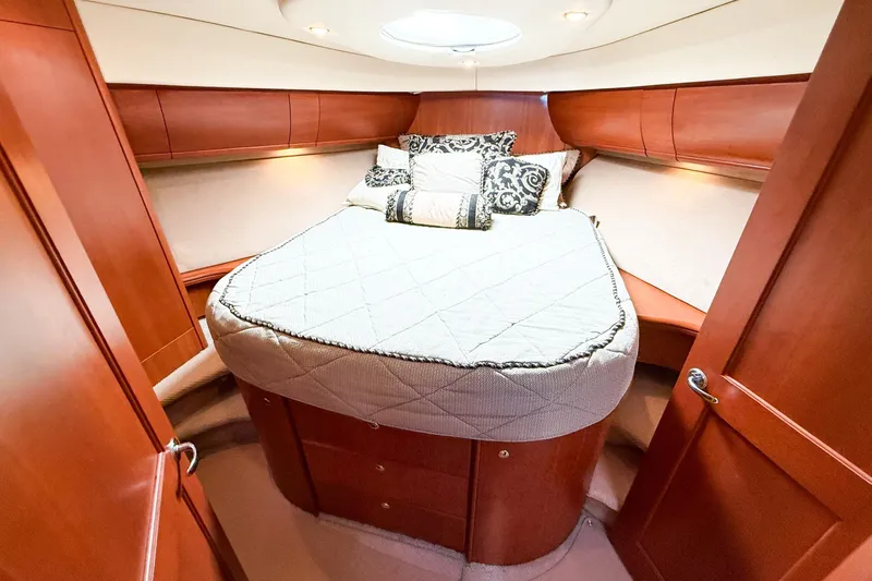 Slide: The Image of Luxurious cabin interior of 2004 Silverton 48 Convertible yacht with cozy bed and elegant wood finish. - 60