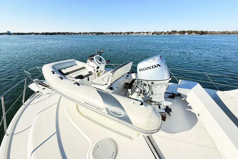 Slide: The Image of 2004 Silverton 48 Convertible yacht with Walker Bay tender and Honda outboard motor. - 7