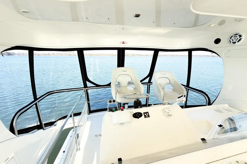 Slide: The Image of Interior view of 2004 Silverton 48 Convertible yacht helm with ocean backdrop. - 15