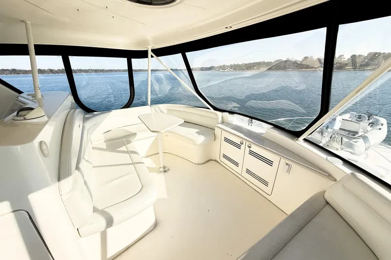 Slide: The Image of Interior of 2004 Silverton 48 Convertible yacht with panoramic windows and seating area. - 17