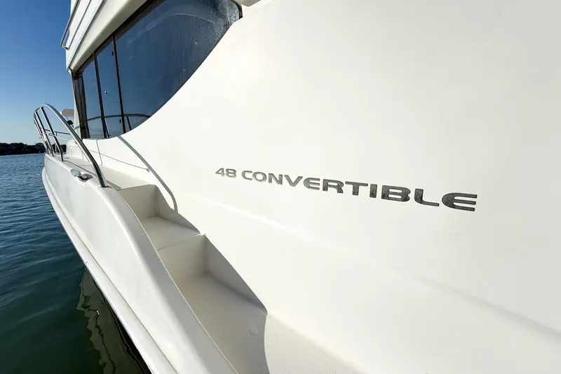 Slide: The Image of 2004 Silverton 48 Convertible yacht on water, showcasing sleek design and branding. - 9