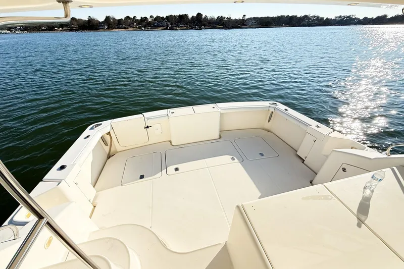 Slide: The Image of 2004 Silverton 48 Convertible yacht deck overlooking serene water and distant shoreline. - 24