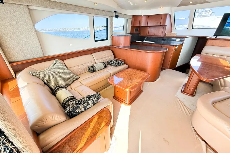 Slide: The Image of Luxurious interior of a 2004 Silverton 48 Convertible yacht with plush seating and elegant wood finishes. - 32