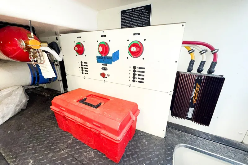 Slide: The Image of Engine room of 2004 Silverton 48 Convertible with control panel and red toolbox. - 85