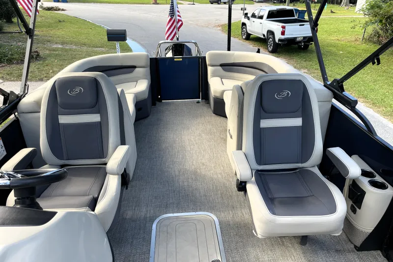 Slide: The Image of 2022 Barletta Cabrio 22QC pontoon boat interior with plush seating and American flags. - 25