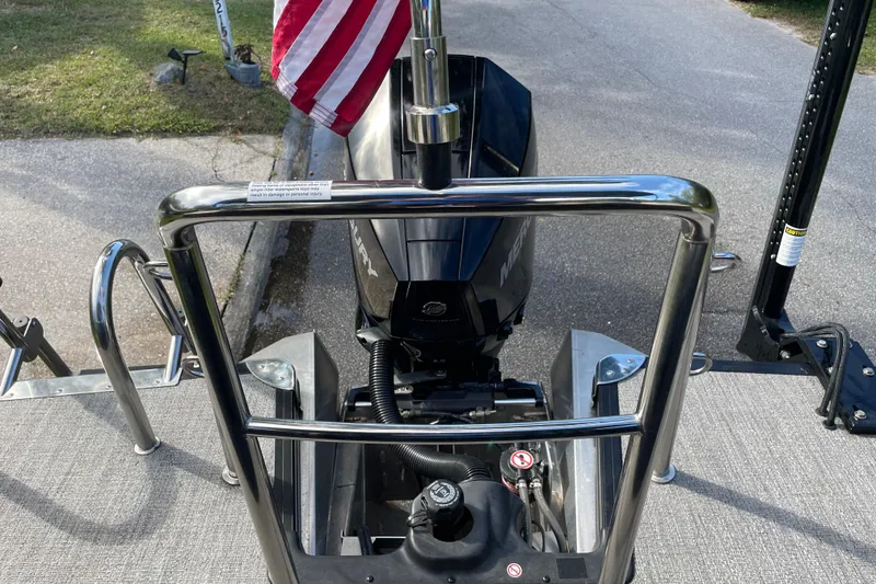 Slide: The Image of 2022 Barletta Cabrio 22QC boat with Mercury engine and American flag. - 38