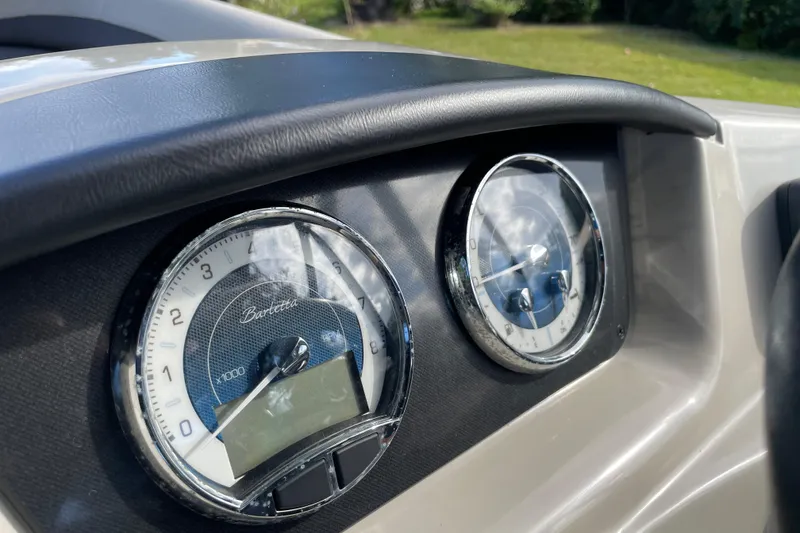 Slide: The Image of Dashboard of 2022 Barletta Cabrio 22QC boat with chrome-rimmed gauges. - 28