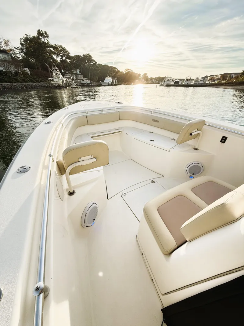 Slide: The Image of 2016 Cobia 296 Center Console boat on serene water at sunset. - 11