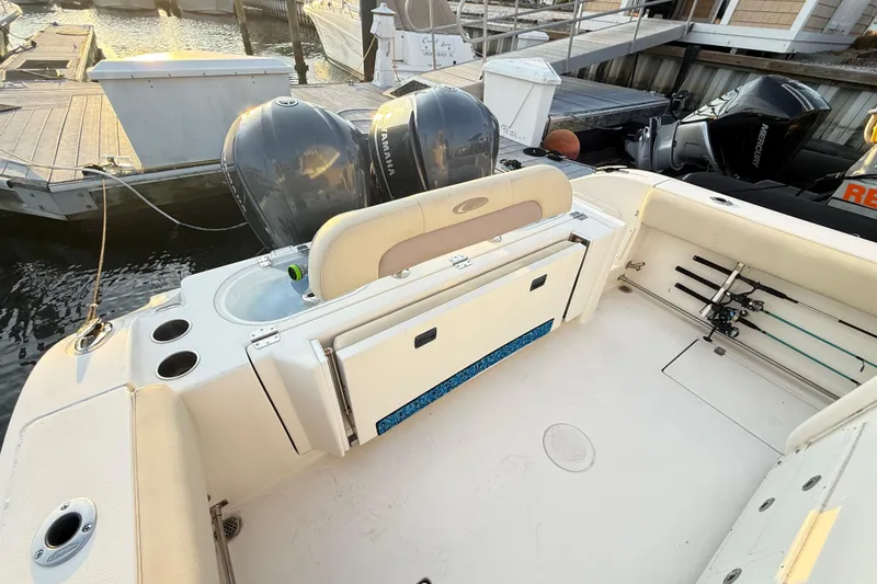 Slide: The Image of 2016 Cobia 296 Center Console boat with dual Yamaha engines at dock. - 20