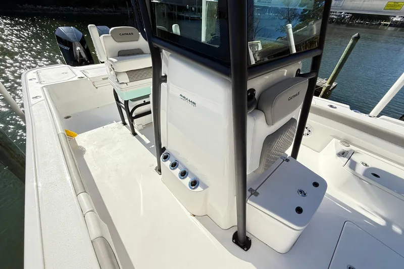 Slide: The Image of 2023 Caymas 281 HB boat interior with seating and storage, docked by the water. - 33