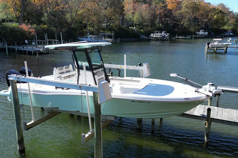 Slide: The Image of 2023 Caymas 281 HB boat docked on a serene lake with autumn foliage. - 8