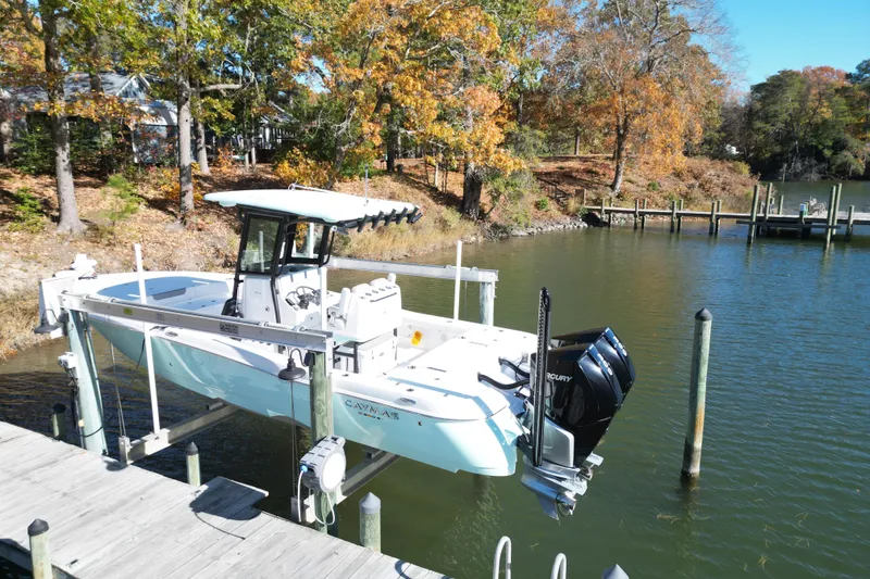 Slide: The Image of 2023 Caymas 281 HB boat on lift by autumn trees and calm water. - 63