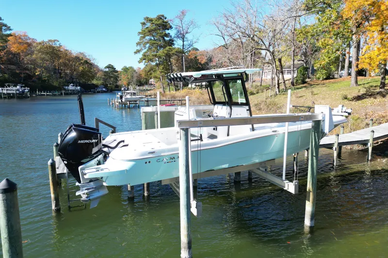 Slide: The Image of 2023 Caymas 281 HB boat docked on a serene lake with autumn foliage. - 3