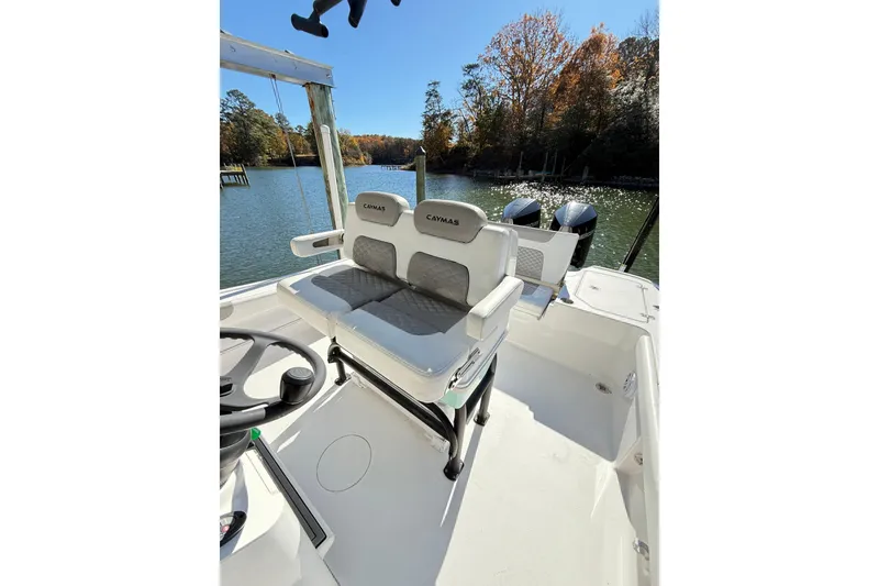 Slide: The Image of 2023 Caymas 281 HB boat interior with dual seats and scenic water view. - 23