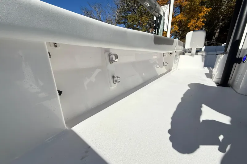 Slide: The Image of 2023 Caymas 281 HB boat interior with white deck and seating, under clear blue sky. - 53