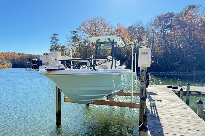 Slide: The Image of 2023 Caymas 281 HB boat docked on a sunny lake with autumn trees. - 6