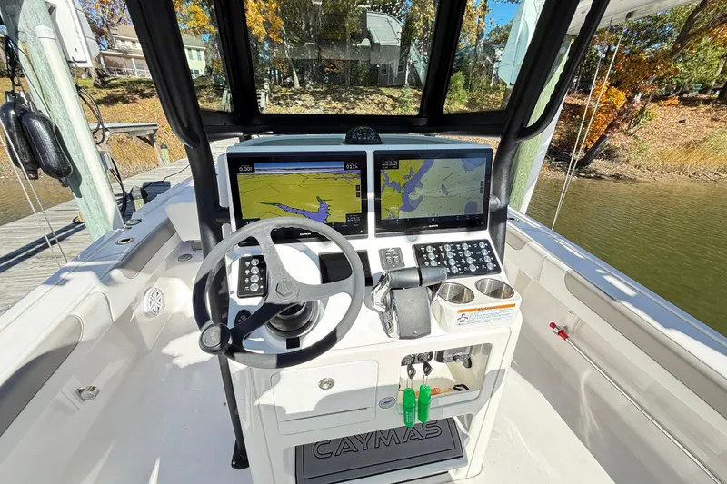 Slide: The Image of 2023 Caymas 281 HB boat cockpit with advanced navigation system and steering wheel. - 13