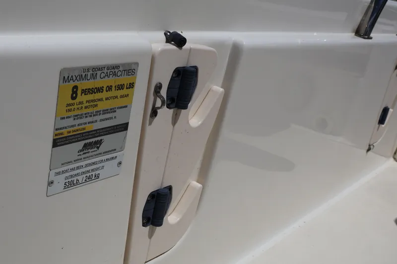 Slide: The Image of 2007 Boston Whaler 180 Dauntless capacity label, showing maximum 8 persons or 1500 lbs. - 35