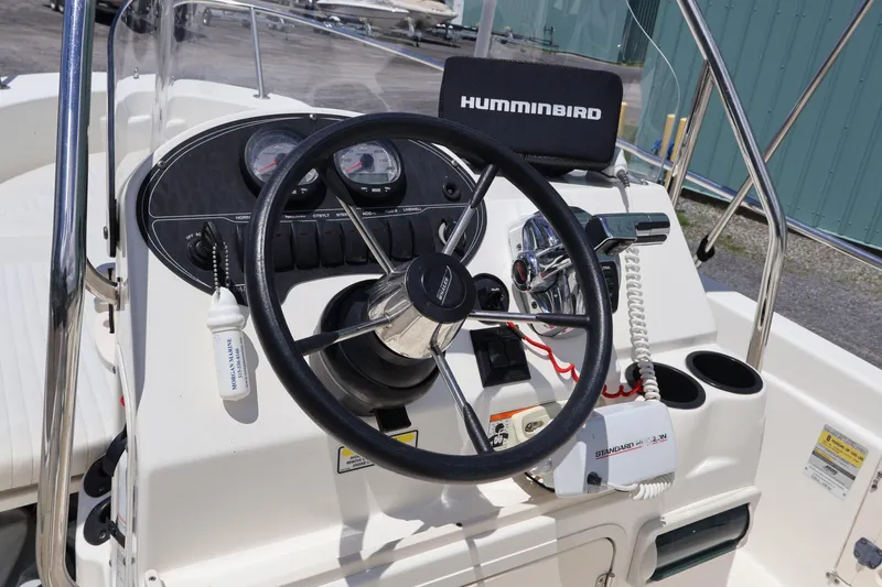 Slide: The Image of 2007 Boston Whaler 180 Dauntless boat dashboard with steering wheel and Humminbird device. - 25