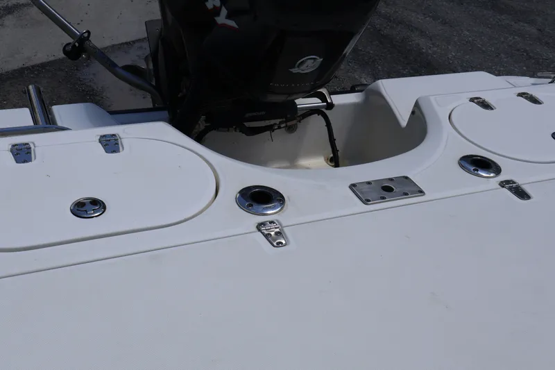 Slide: The Image of 2007 Boston Whaler 180 Dauntless boat stern with motor and storage compartments. - 54